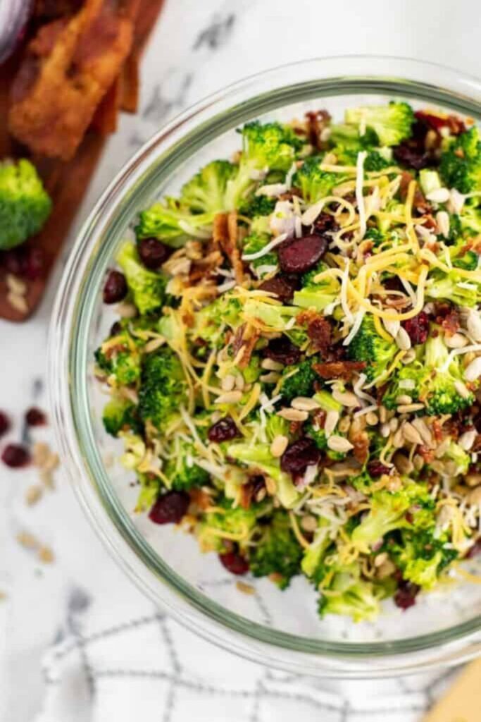 overhead view of broccoli salad with bacon and cranberries in it