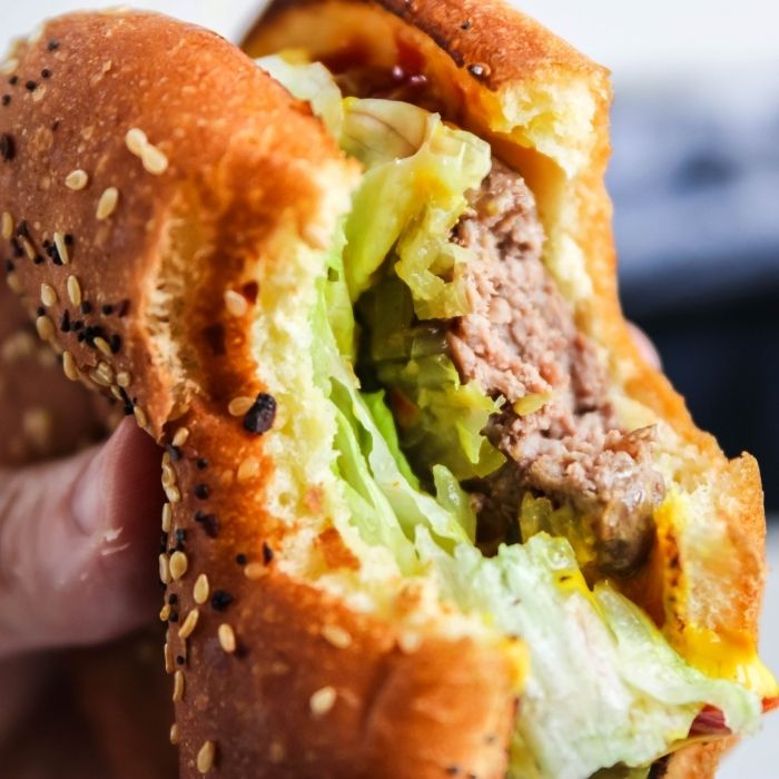 holding burger with bite taken out