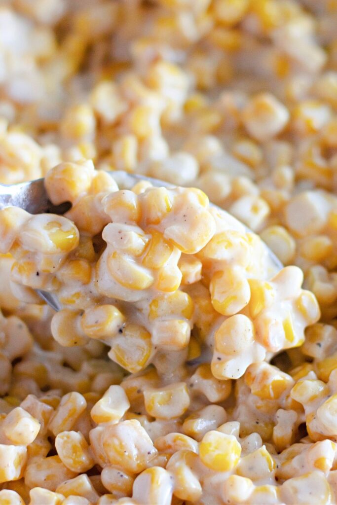creamed corn with a spoonful above the bowl