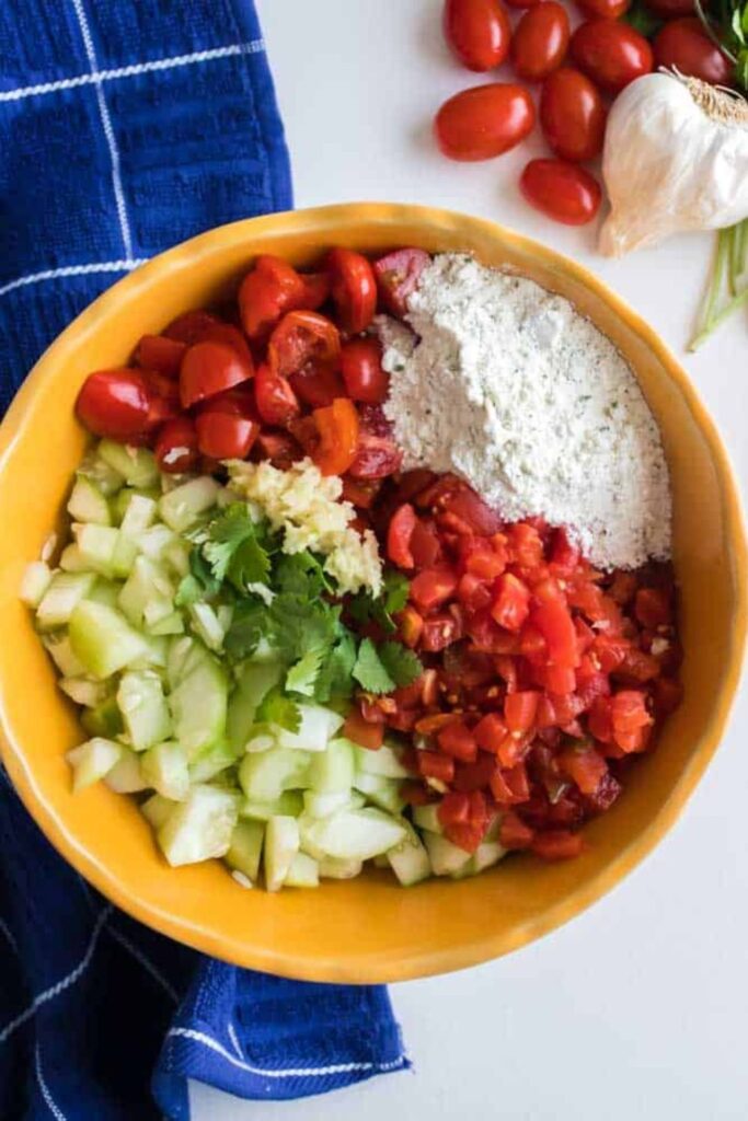 bowl with diced vegetables for cucumber salsa in it