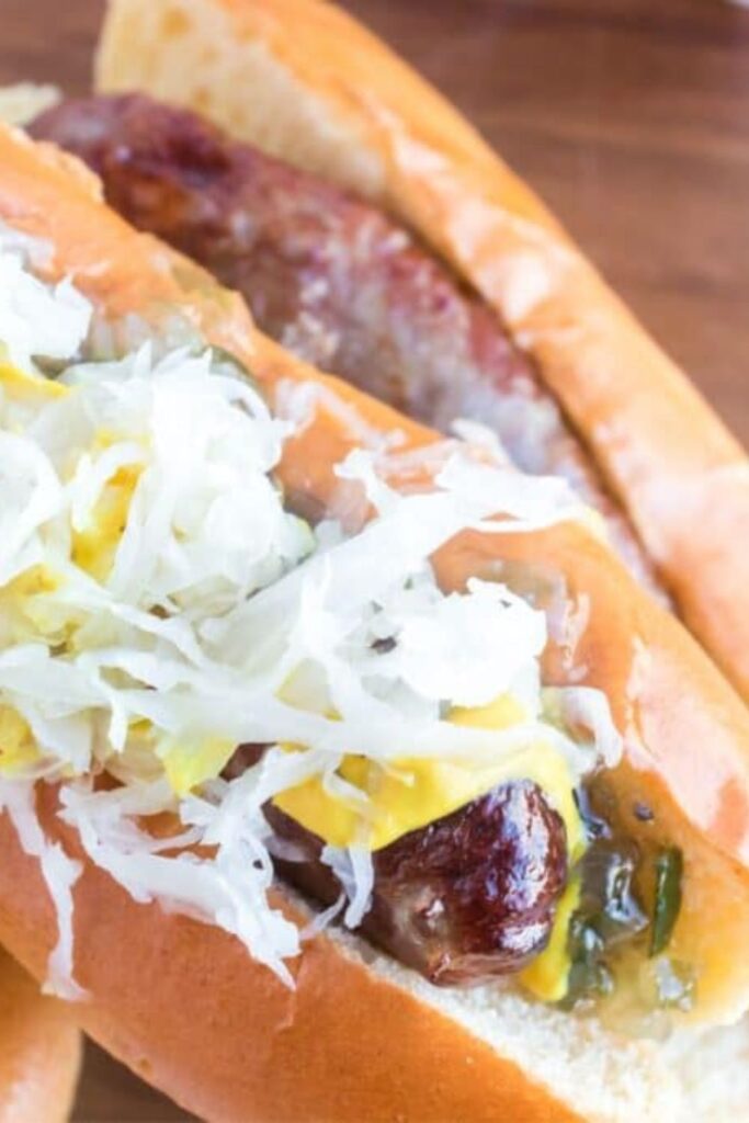 bratwurst with brats topped with cheese, mustard, pickles, etc