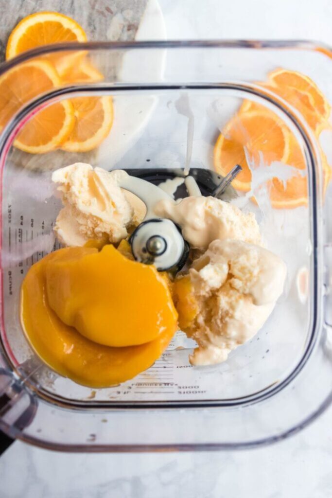 frozen orange juice and ice cream in a blender