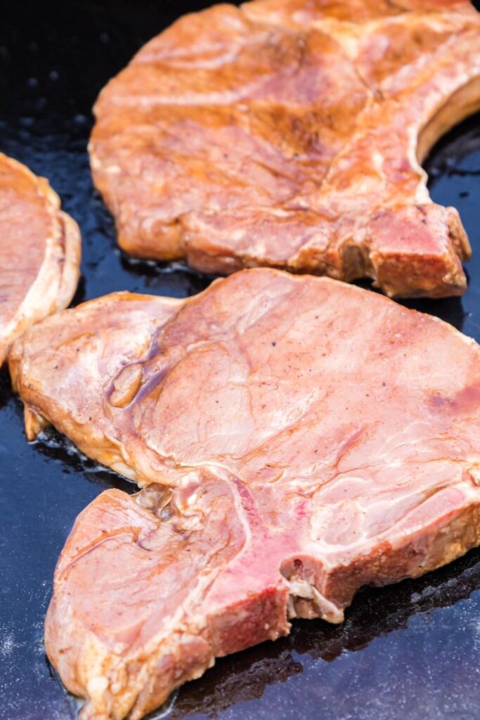 raw pork chops on griddle