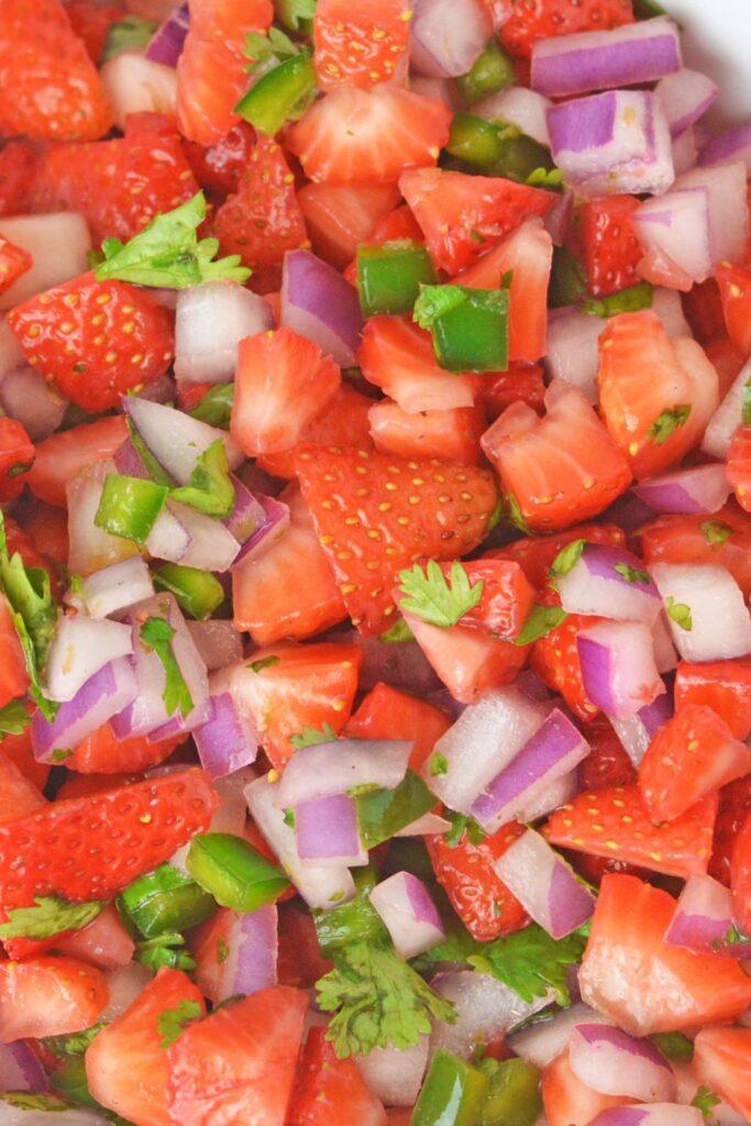 close up of chopped strawberry salsa in a bowl